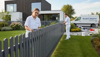 Boise, ID painters staining a wood fence to protect and improve curb appeal
